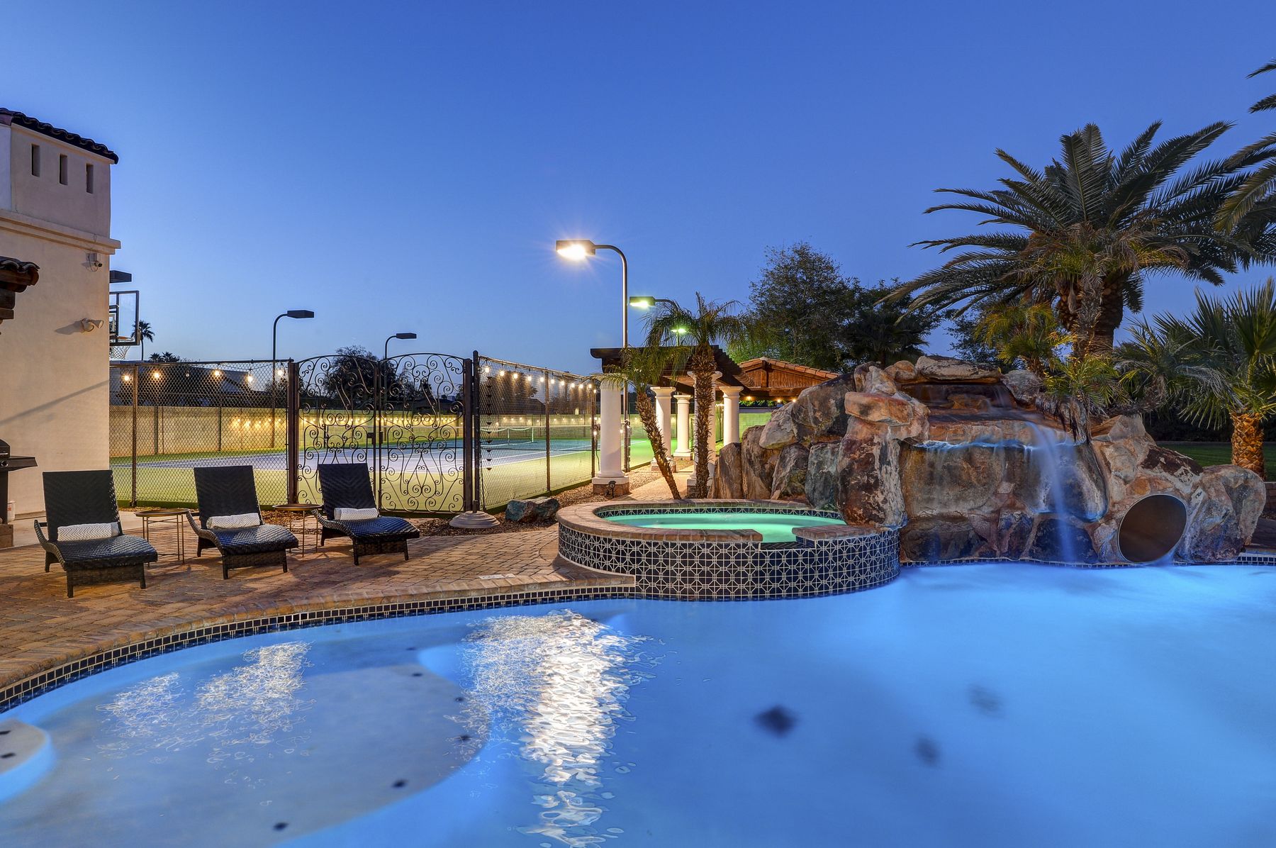 Pool, Spa & Tennis Court at Night